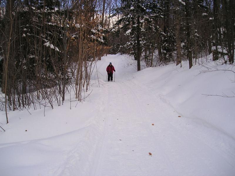 Stinson (21).JPG - To save time we decided to follow the snow mobile road to the lower part of the trail. At one point two snow mobilers passed us on their way to the top. Lucky thing we had our red jackets on.